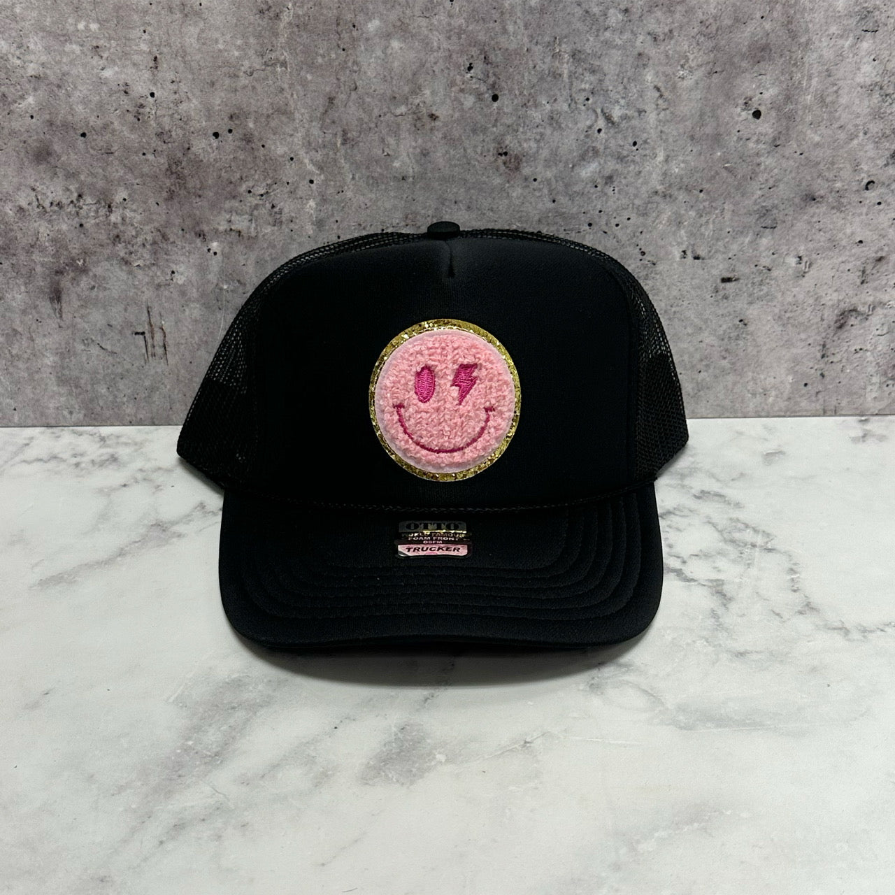 Pink Smiley Bolt Eye Patch Trucker Hat